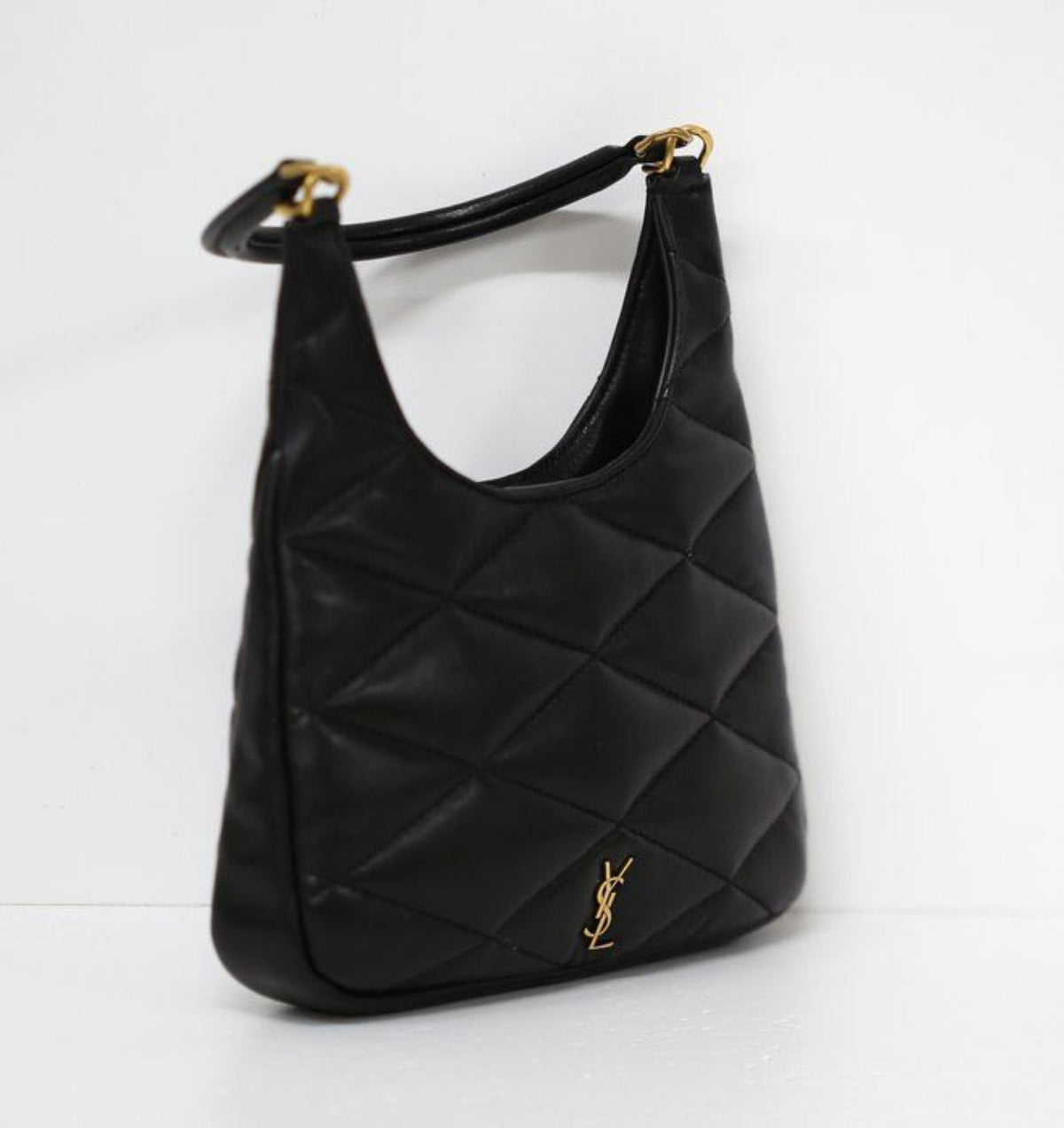 Saint Laurent black hobo bag diamond quilted lambskin with gold Cassandre logo.