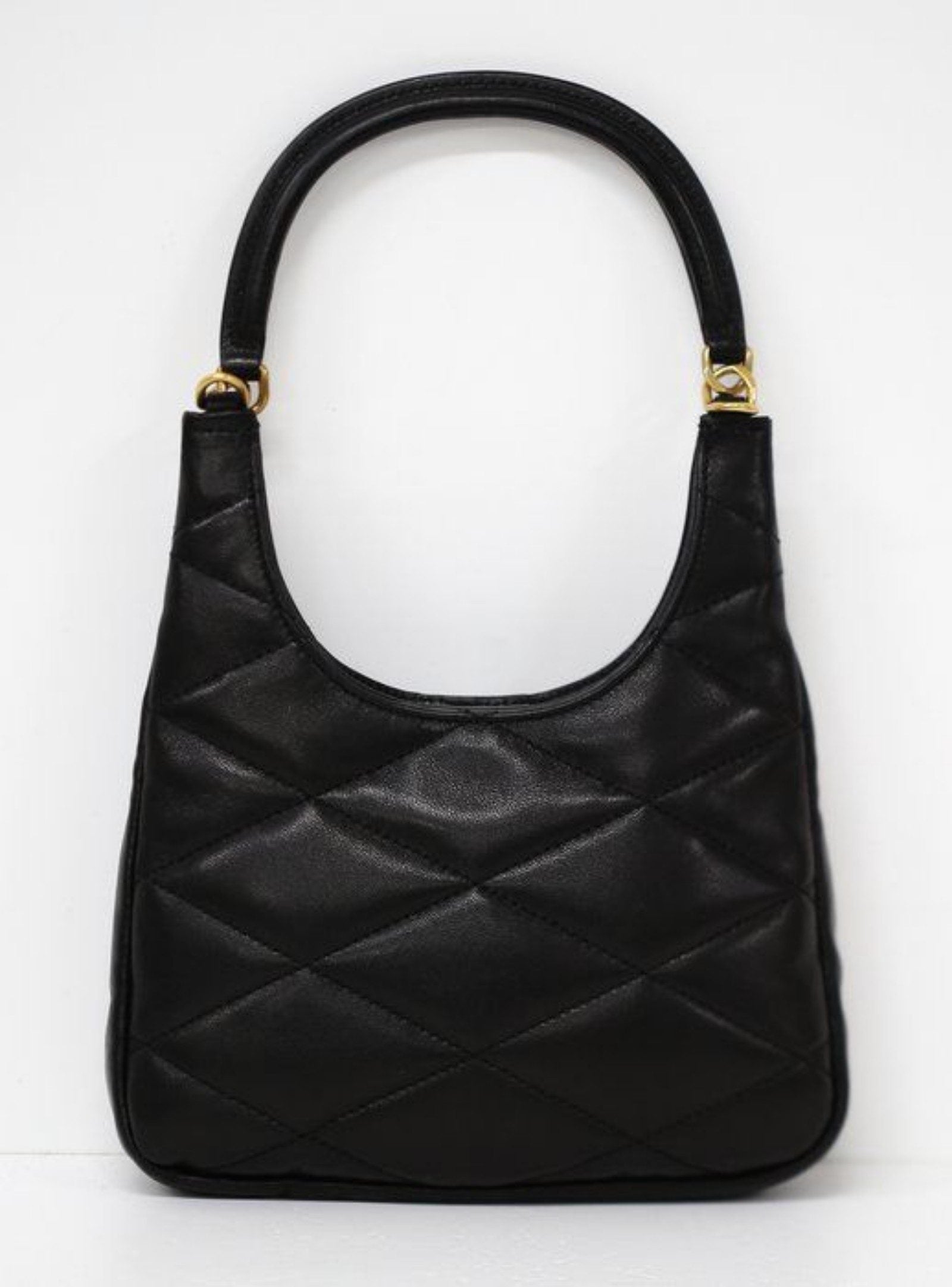 Saint Laurent black hobo bag diamond quilted lambskin with gold Cassandre logo.