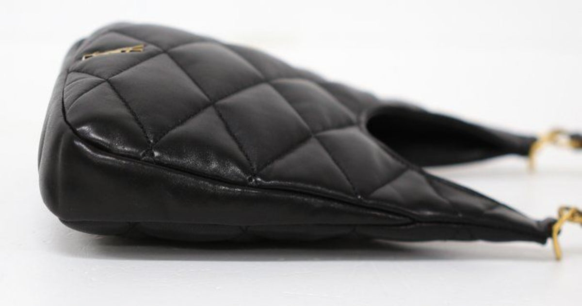 Saint Laurent black hobo bag diamond quilted lambskin with gold Cassandre logo.