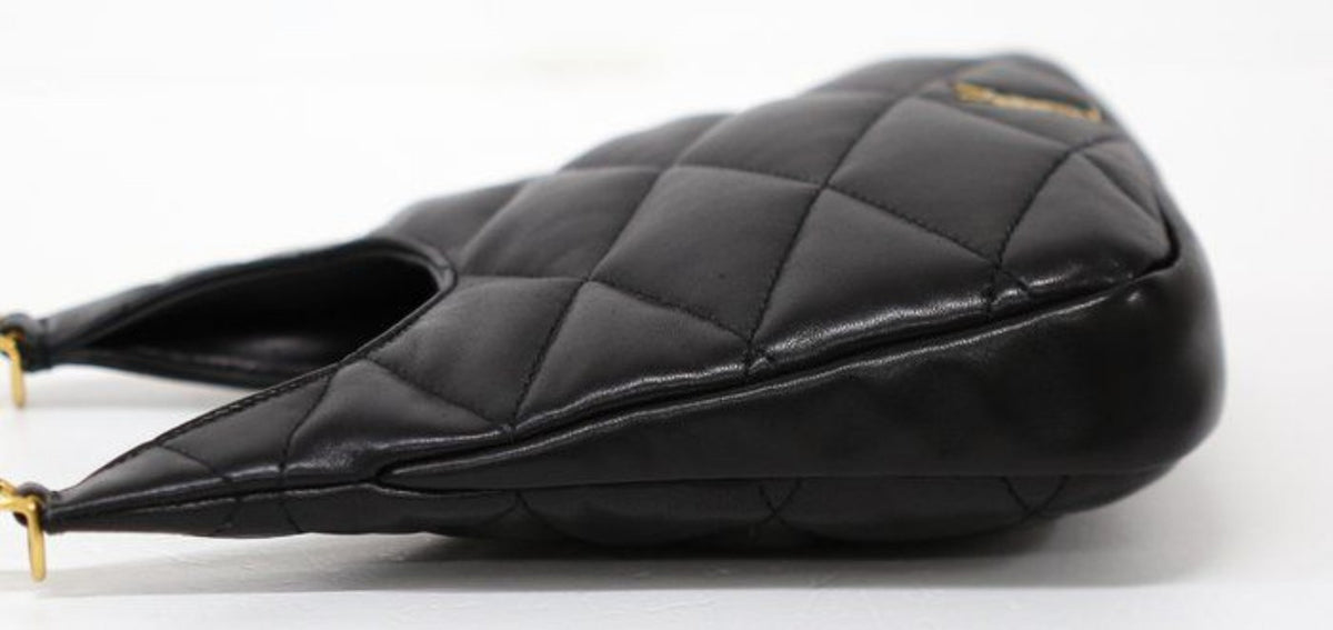Saint Laurent black hobo bag diamond quilted lambskin with gold Cassandre logo.